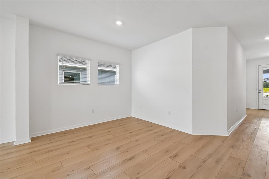 5836 Native Oak Street Mount Dora, FL 32757 - Photo 9 of 39 a view of an empty room with wooden floor and a window