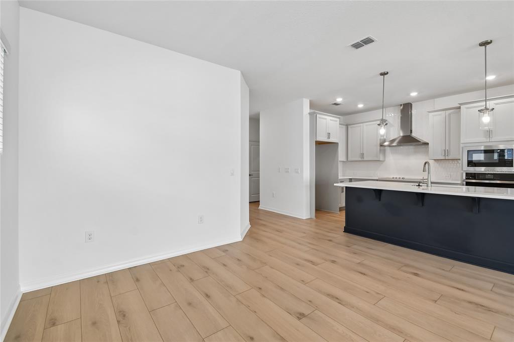 5836 Native Oak Street Mount Dora, FL 32757 - Photo 10 of 39 a view of kitchen with wooden floor