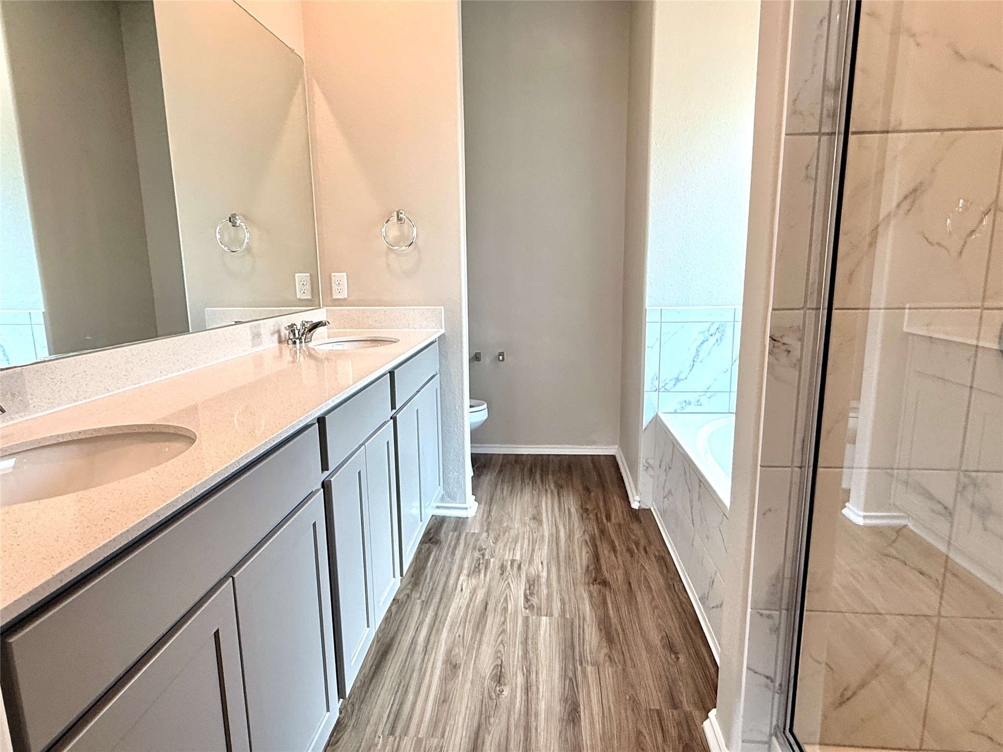 129 Perfect World Loop Jarrell, TX 76537 - Photo 16 of 31 Dual vanities with stone counters enhance this well-appointed bathroom.