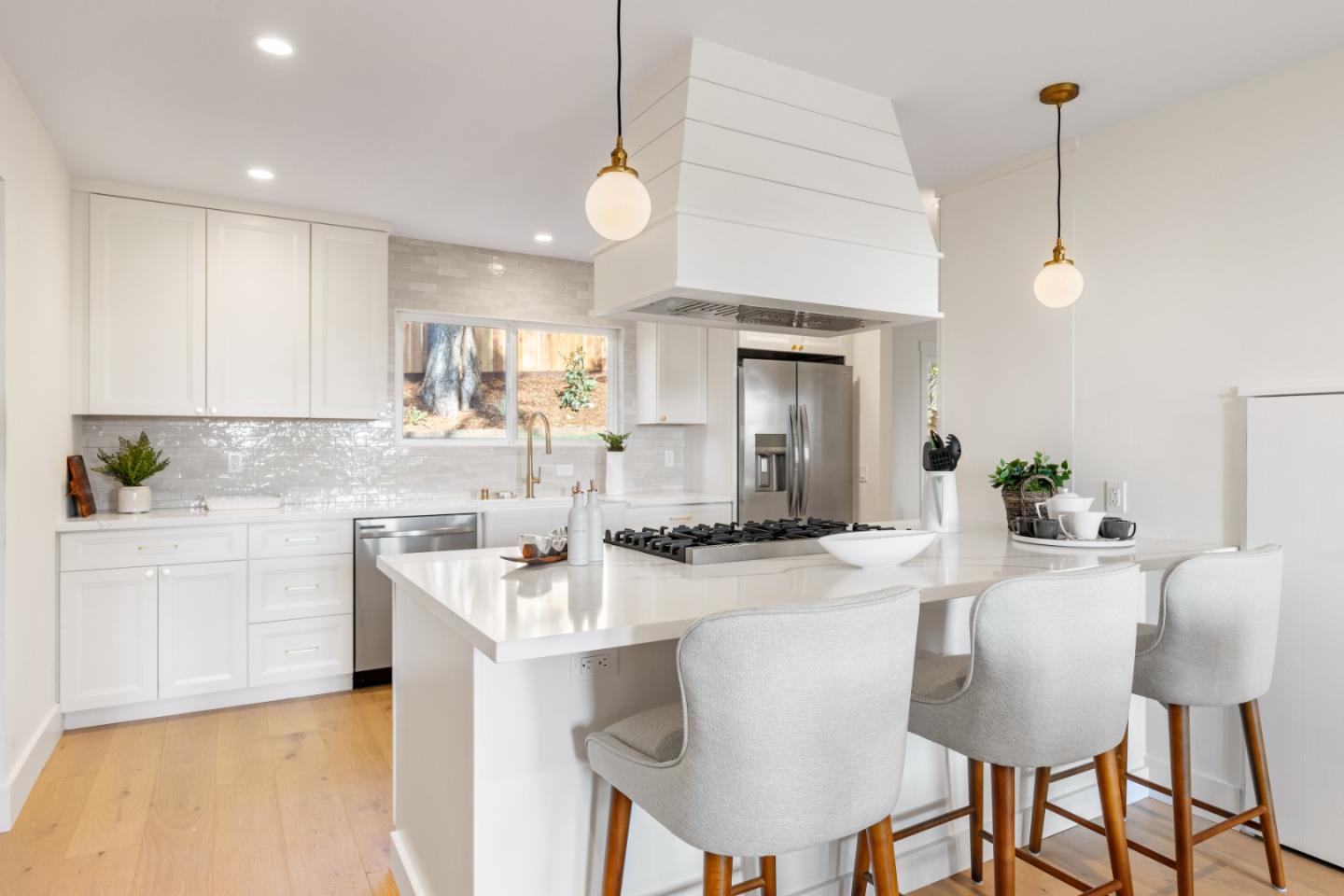 309 Channing Way Pacifica, CA 94044 - Photo 14 of 42 a kitchen with kitchen island granite countertop a sink and cabinets