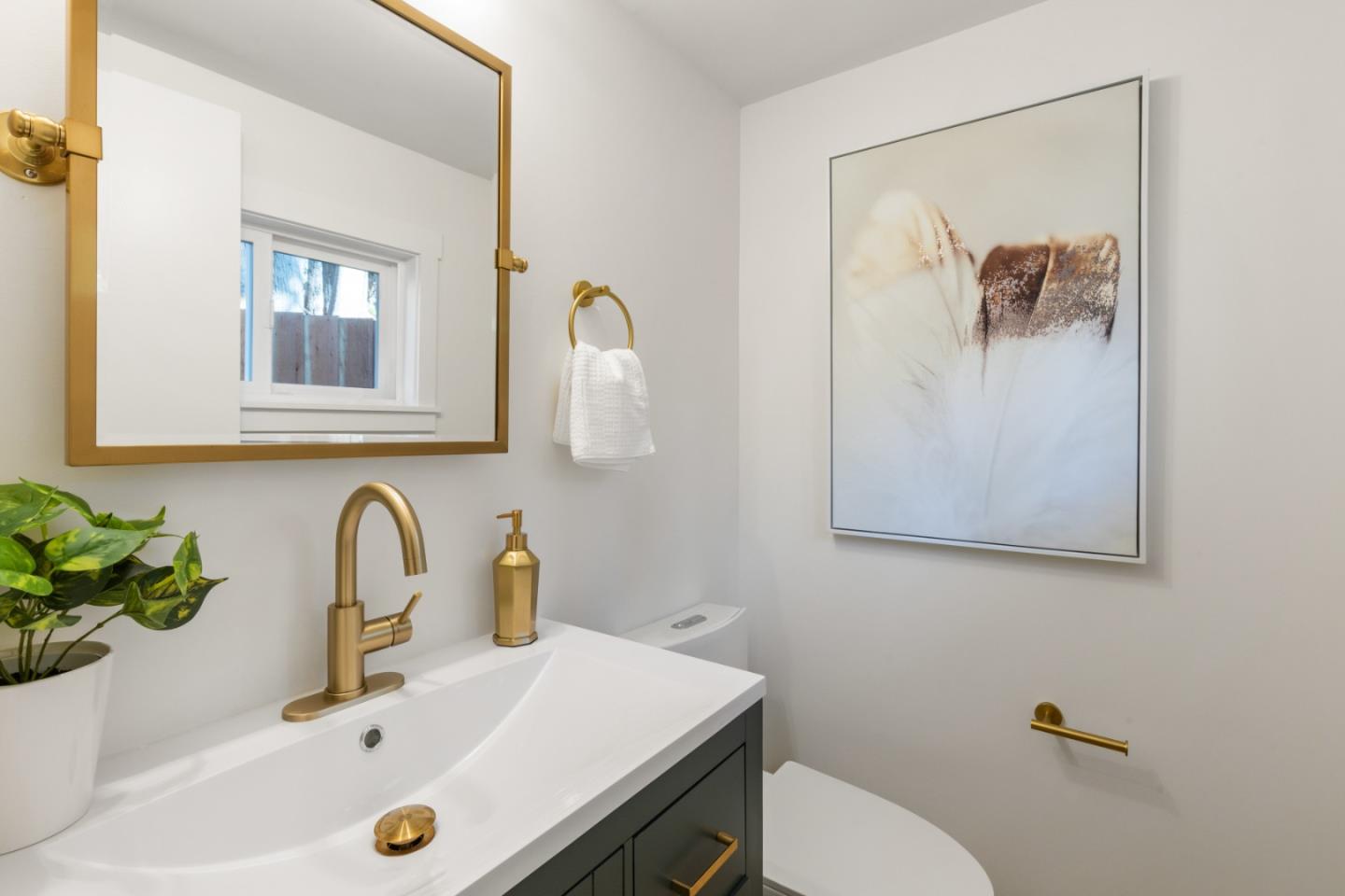 309 Channing Way Pacifica, CA 94044 - Photo 20 of 42 a bathroom with a sink a toilet and mirror