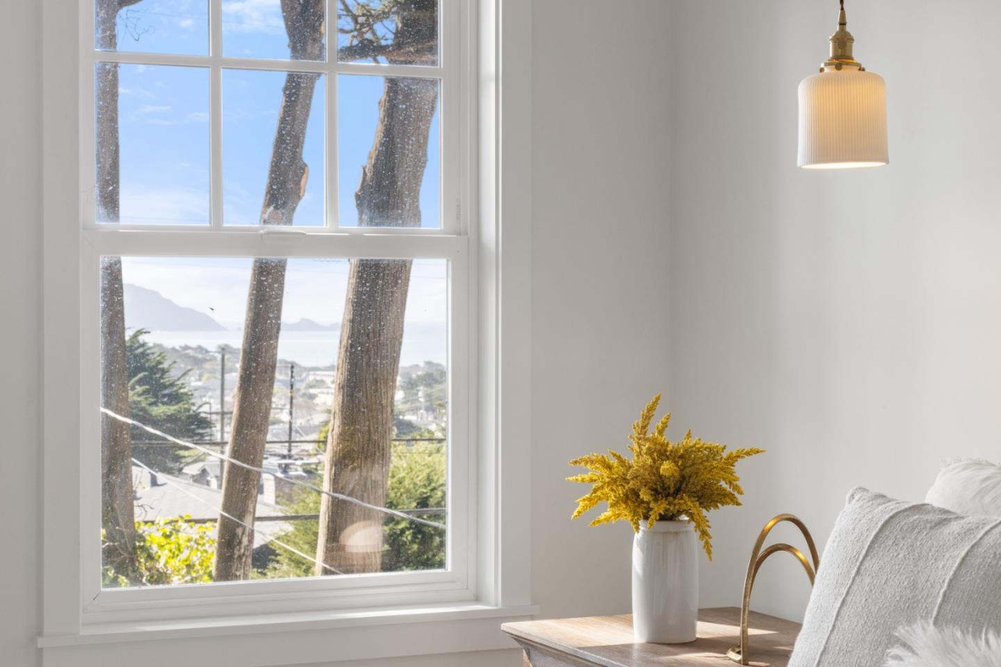 309 Channing Way Pacifica, CA 94044 - Photo 32 of 42 a vase of flowers sitting on a table with a window