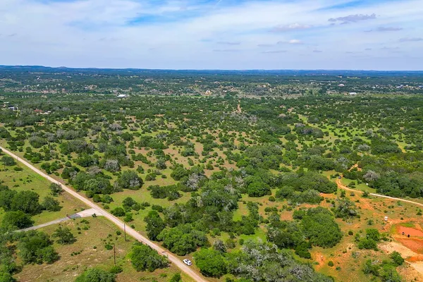 a view of a city with lush green forest