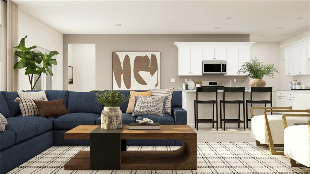 512 Almere Drive Hampton, GA 30228 - Photo 9 of 37 a living room with furniture potted plant and a table