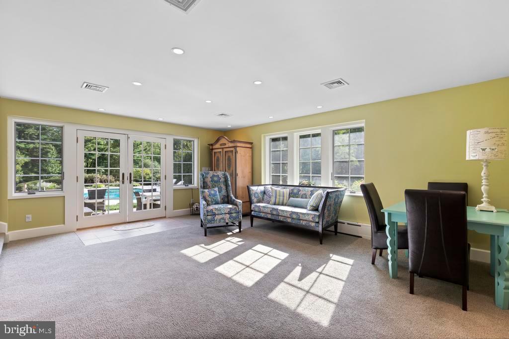 1038 Mill Rd Circle Rydal, PA 19046 - Photo 19 of 61 a living room with furniture and a floor to ceiling window