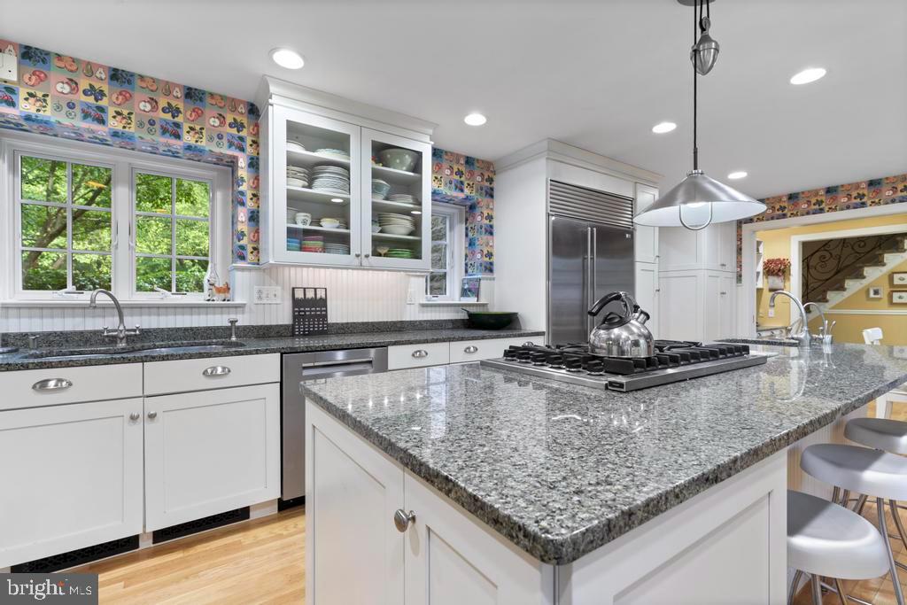 1038 Mill Rd Circle Rydal, PA 19046 - Photo 24 of 61 a kitchen with stainless steel appliances granite countertop a sink a stove and a wooden cabinets