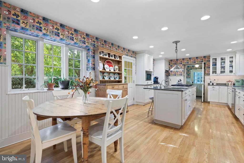 1038 Mill Rd Circle Rydal, PA 19046 - Photo 25 of 61 a kitchen with stainless steel appliances kitchen island granite countertop a table and chairs in it