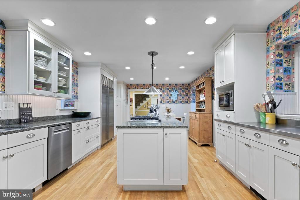 1038 Mill Rd Circle Rydal, PA 19046 - Photo 26 of 61 a large kitchen with stainless steel appliances kitchen island granite countertop a sink and cabinets
