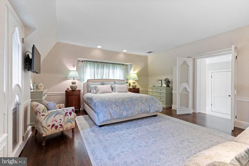 1038 Mill Rd Circle Rydal, PA 19046 - Photo 30 of 61 a spacious bedroom with a bed and wooden floor