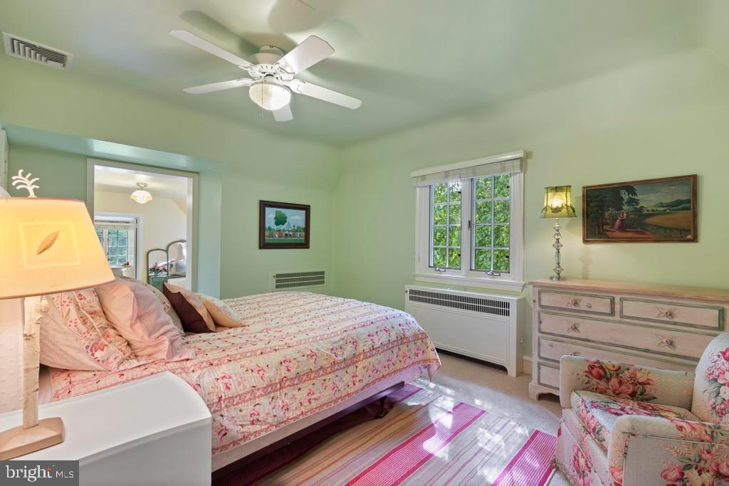 1038 Mill Rd Circle Rydal, PA 19046 - Photo 34 of 61 a bedroom with a large bed and a chandelier