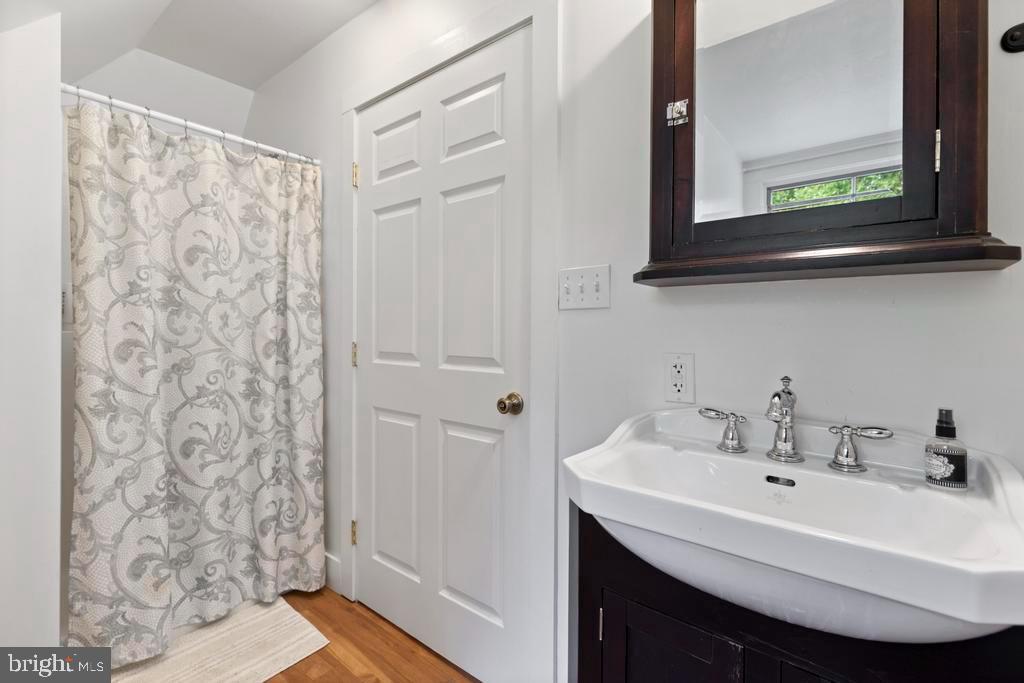 1038 Mill Rd Circle Rydal, PA 19046 - Photo 50 of 61 a bathroom with a sink and a mirror