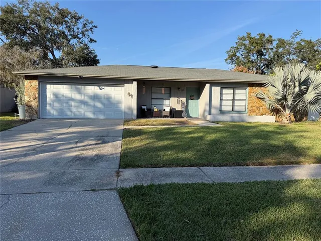 a view of a house with backyard and porch