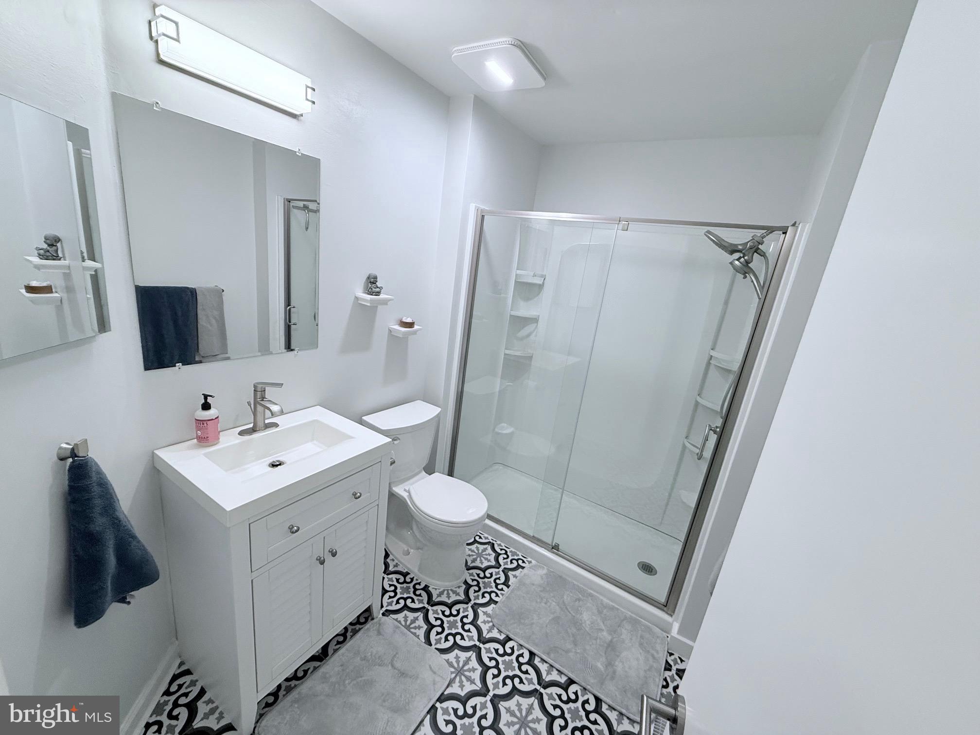3603 Fenwick Lane Mount Laurel, NJ 08054 - Photo 13 of 17 a view of a bathroom with a sink a mirror and a toilet