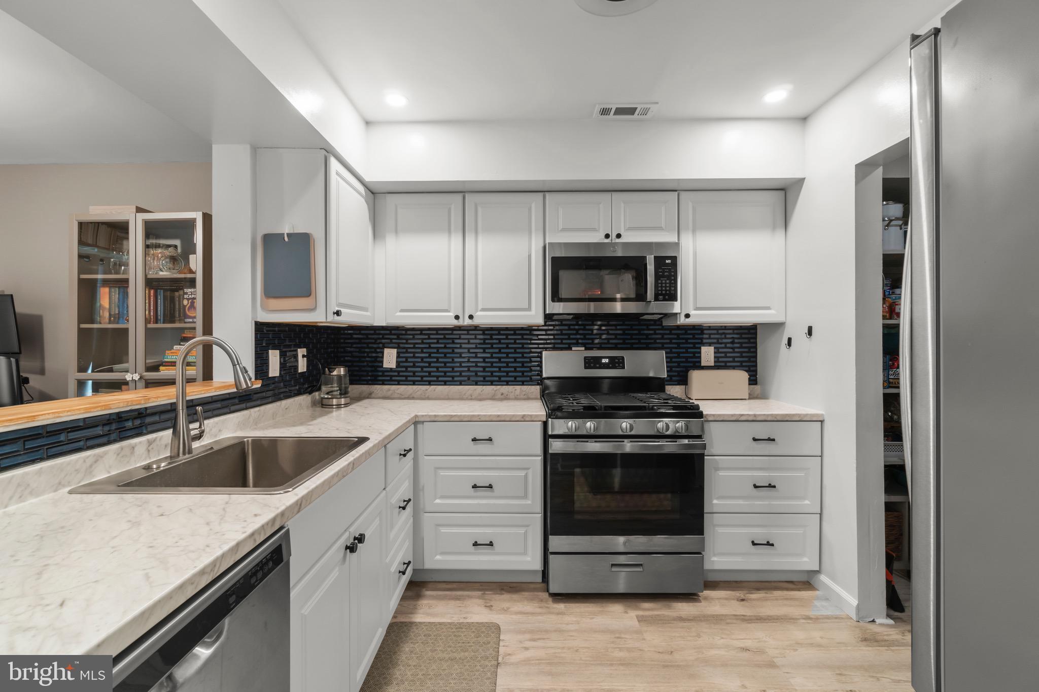 3603 Fenwick Lane Mount Laurel, NJ 08054 - Photo 2 of 17 a kitchen with stainless steel appliances granite countertop a sink stove and refrigerator