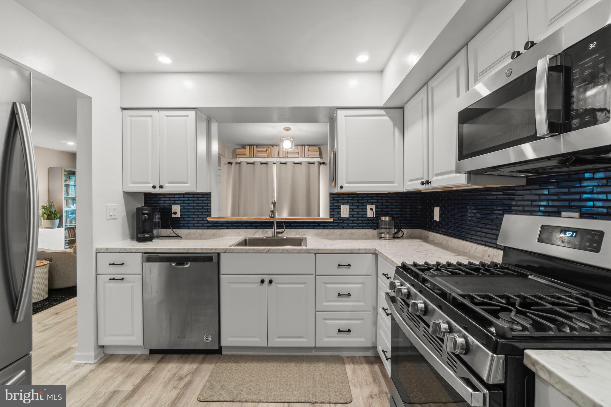 3603 Fenwick Lane Mount Laurel, NJ 08054 - Photo 3 of 17 a kitchen with stainless steel appliances granite countertop a stove top oven a sink dishwasher and a microwave oven with cabinets