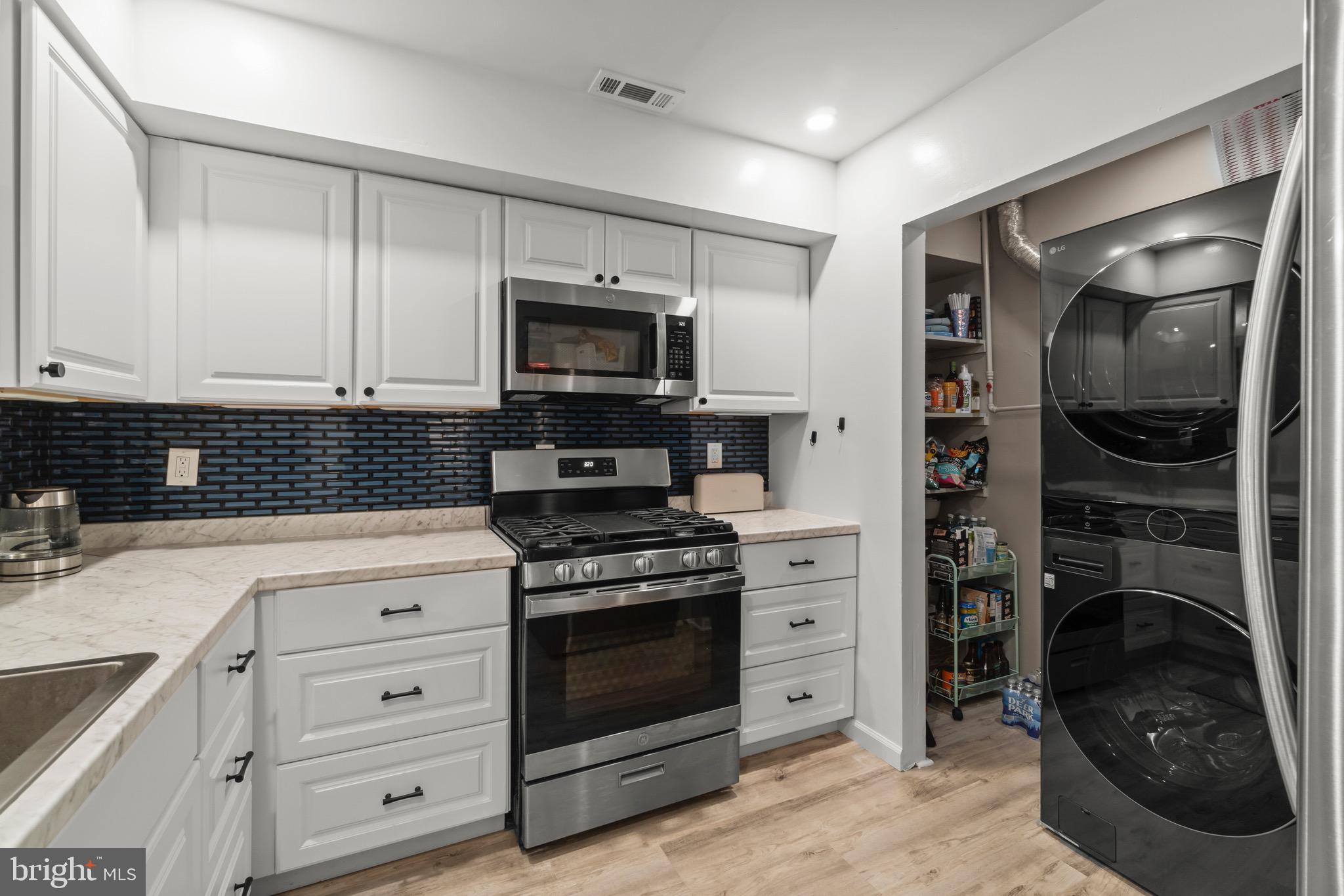 3603 Fenwick Lane Mount Laurel, NJ 08054 - Photo 4 of 17 a kitchen with white cabinets and stainless steel appliances