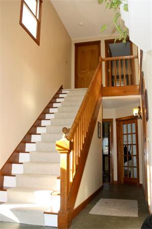 90 Bullard Road Princeton, MA 01541 - Photo 15 of 30 a view of staircase with lots of frames on wall and a chandelier