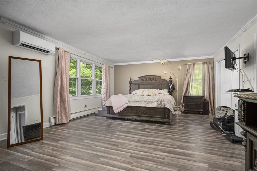 50 Haverhill Road Topsfield, MA 01983 - Photo 23 of 42 a bedroom with a bed a flat screen tv and a large window