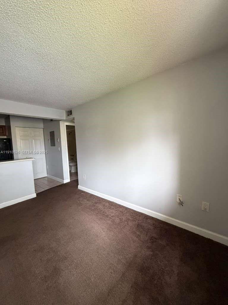 351 Palm Way, Unit 207 Pembroke Pines, FL 33025 - Photo 2 of 12 a view of empty room with window and stairs