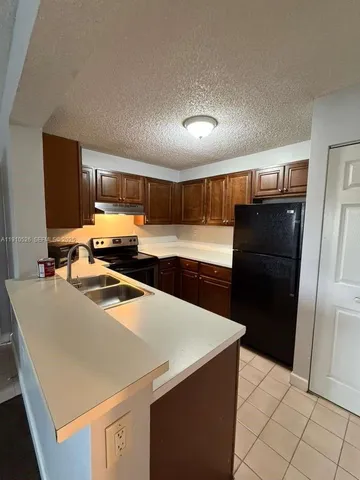 a kitchen with stainless steel appliances a refrigerator and a stove