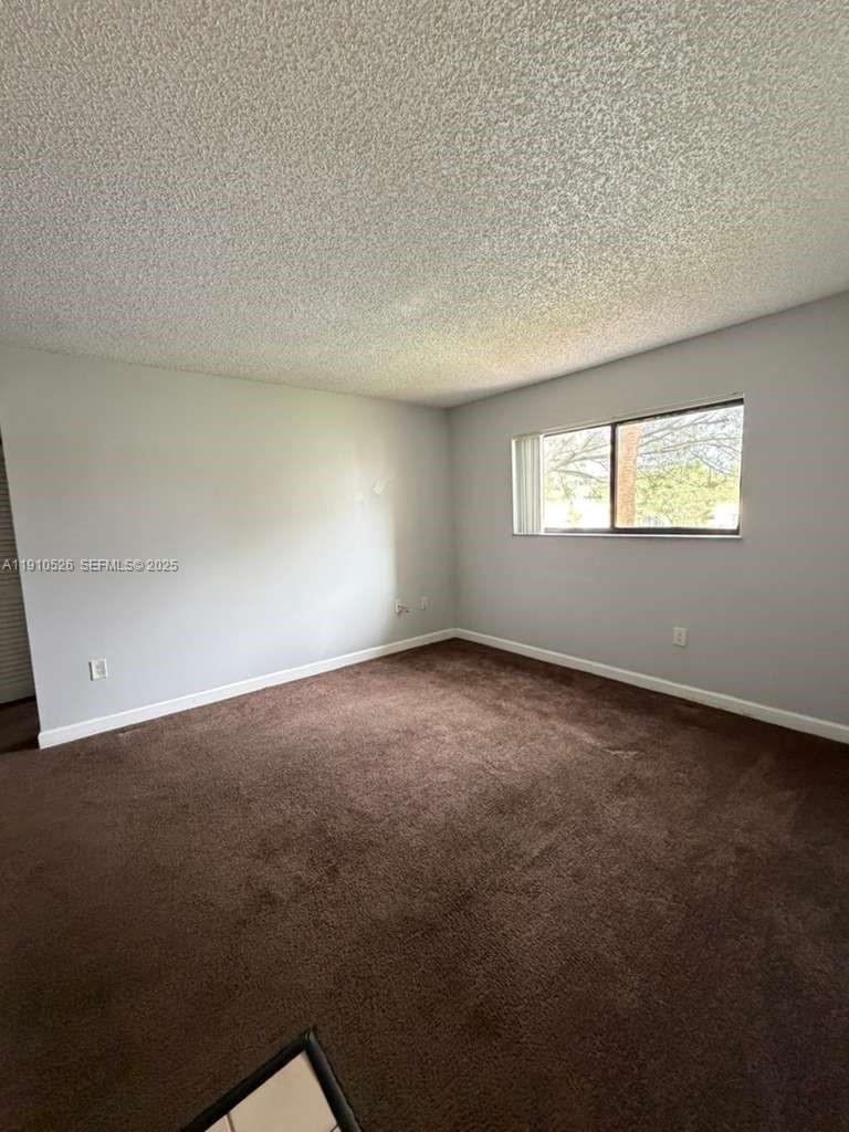 351 Palm Way, Unit 207 Pembroke Pines, FL 33025 - Photo 6 of 12 an empty room with windows
