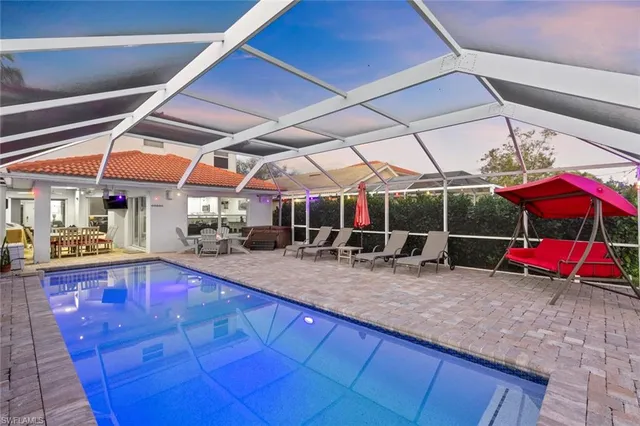 a view of a patio with table and chairs under an umbrella