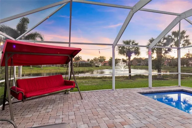 a spacious bedroom with a bed and a chandelier