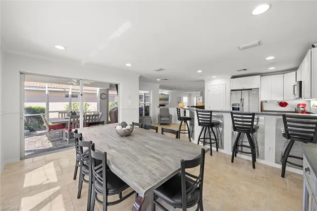 a kitchen with granite countertop a sink and white cabinets