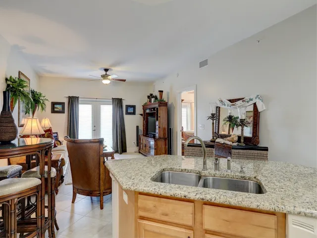 a kitchen with stainless steel appliances granite countertop a sink and a refrigerator