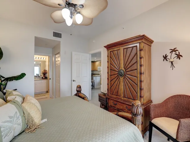 a bedroom with bed and a chandelier