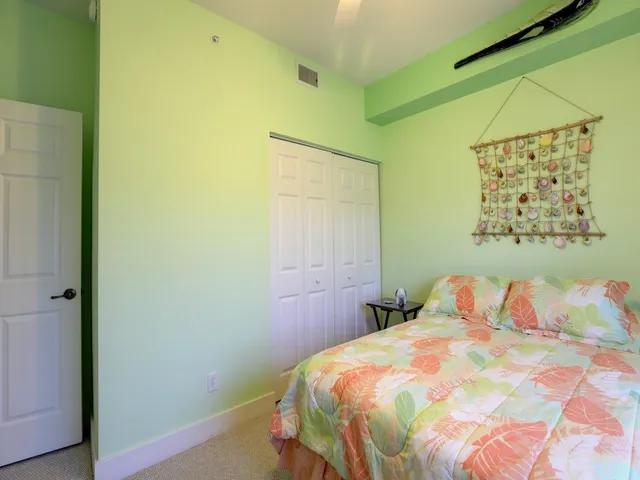 a bedroom with a bed and painting on the wall