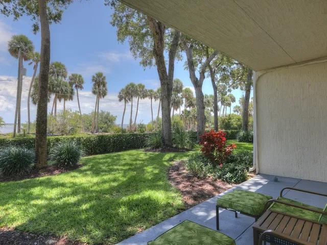 a front view of a house with a yard and outdoor seating