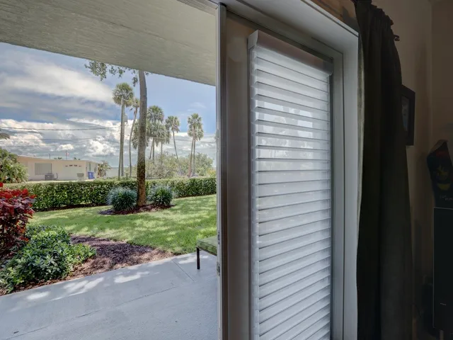 a view of a back yard from a corridor