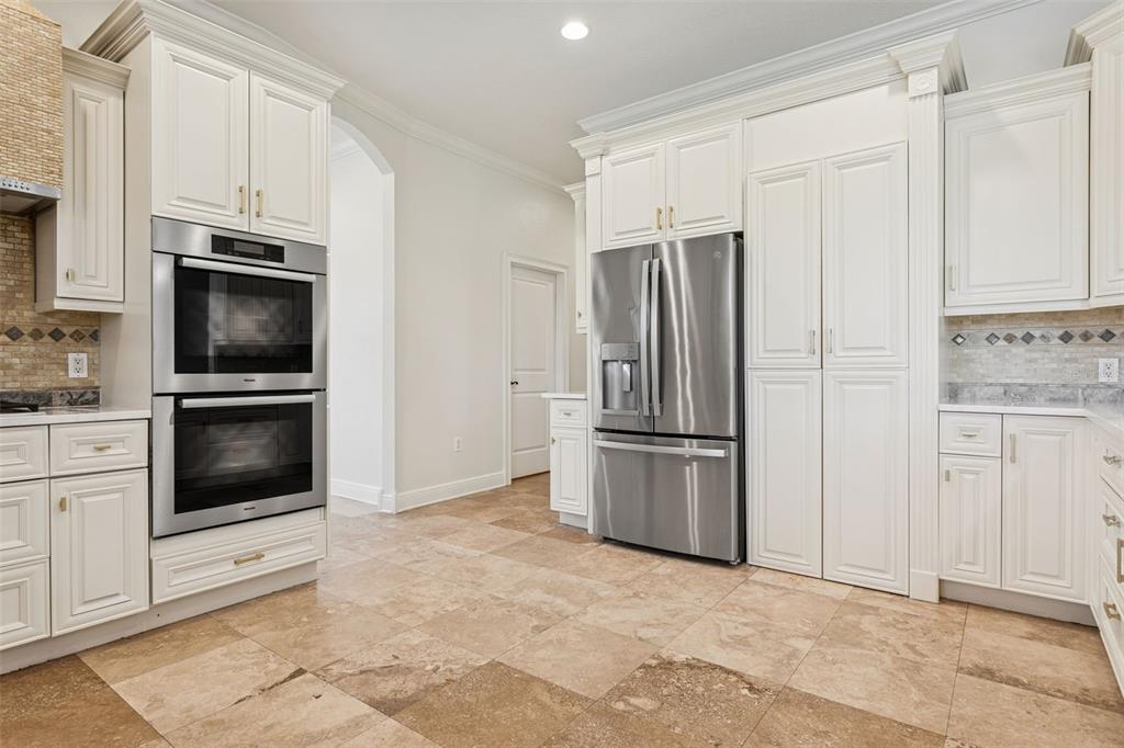 11606 Lipsey Road Tampa, FL 33618 - Photo 15 of 100 a kitchen with white cabinets and stainless steel appliances
