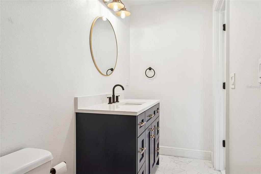 11606 Lipsey Road Tampa, FL 33618 - Photo 32 of 100 a bathroom with a toilet a sink and mirror
