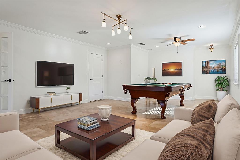 11606 Lipsey Road Tampa, FL 33618 - Photo 34 of 100 a living room with furniture and a flat screen tv