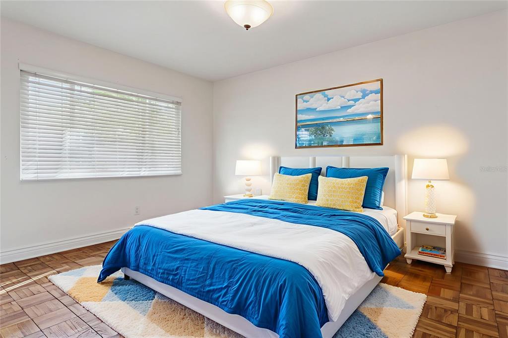 11606 Lipsey Road Tampa, FL 33618 - Photo 36 of 100 a bedroom with a bed and a painting on the wall