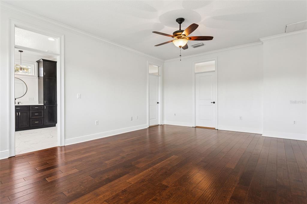 11606 Lipsey Road Tampa, FL 33618 - Photo 49 of 100 a view of empty room with wooden floor and fan
