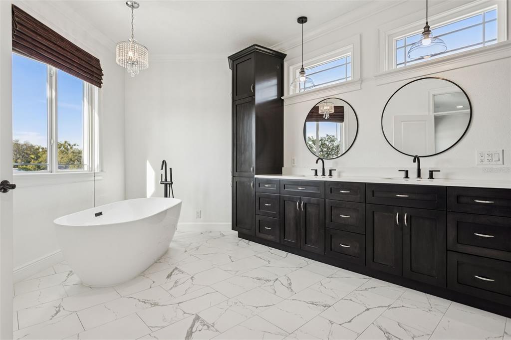 11606 Lipsey Road Tampa, FL 33618 - Photo 50 of 100 a spacious bathroom with a tub sink and mirror