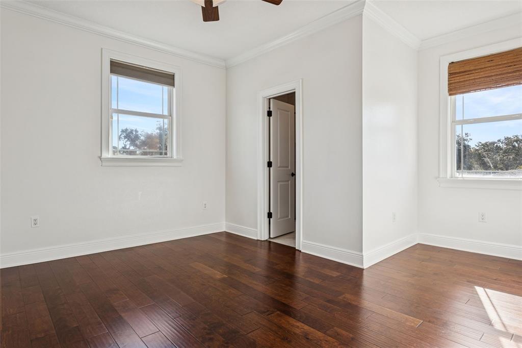 11606 Lipsey Road Tampa, FL 33618 - Photo 60 of 100 a view of an empty room with wooden floor and a window