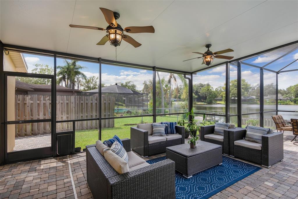 11606 Lipsey Road Tampa, FL 33618 - Photo 64 of 100 a living room with furniture and a floor to ceiling window