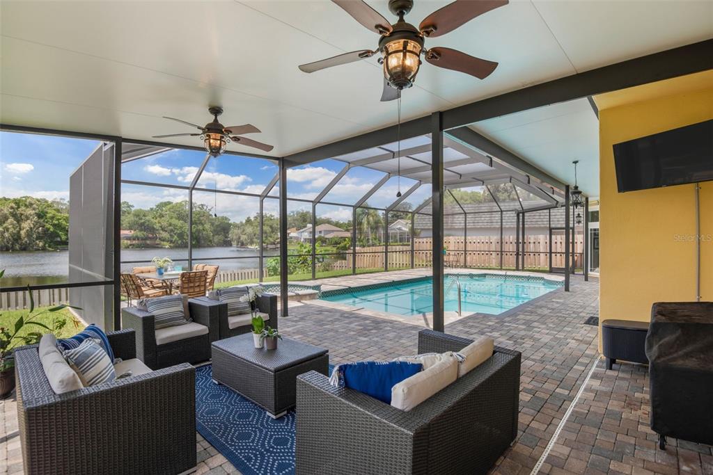 11606 Lipsey Road Tampa, FL 33618 - Photo 65 of 100 a living room with furniture and a floor to ceiling window
