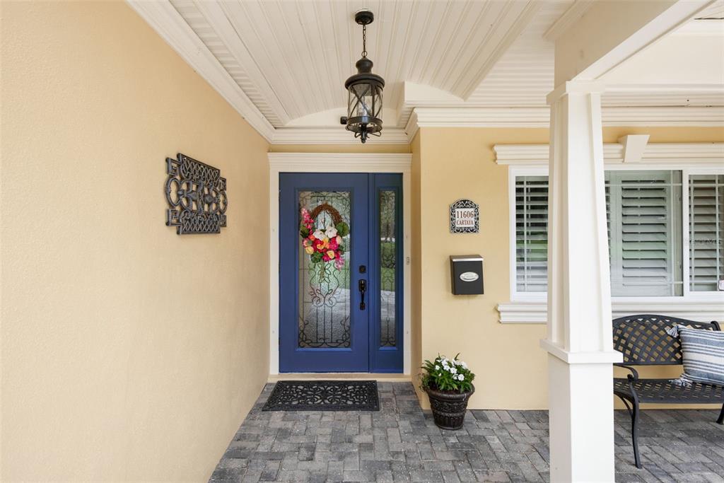 11606 Lipsey Road Tampa, FL 33618 - Photo 7 of 100 a view of a hallway with wooden floor and a chandelier