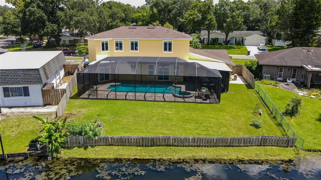 11606 Lipsey Road Tampa, FL 33618 - Photo 76 of 100 a view of a house with a swimming pool lawn chairs and a yard