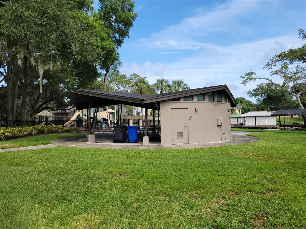 11606 Lipsey Road Tampa, FL 33618 - Photo 90 of 100 a view of a white house with a big yard and large trees