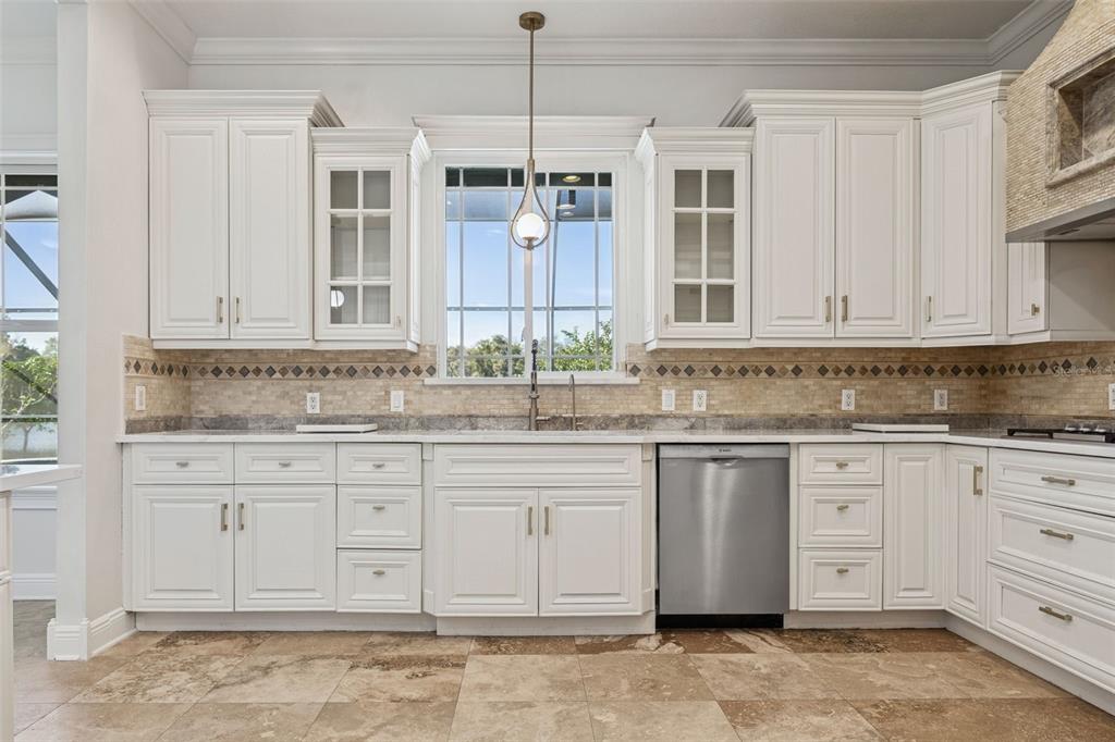 11606 Lipsey Road Tampa, FL 33618 - Photo 10 of 100 a kitchen with granite countertop white cabinets white appliances with a sink and dishwasher