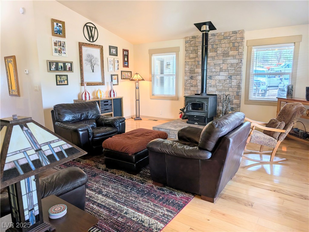 8320 Mother Lode Road Pioche, NV 89043 - Photo 24 of 46 Living area featuring a wood stove, lofted ceiling, and light wood flooring