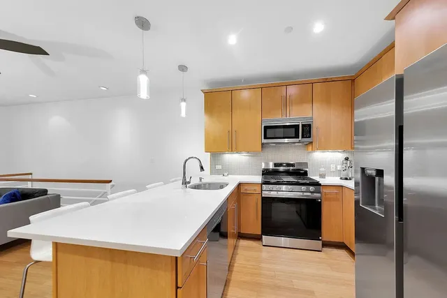 a kitchen with a stove a sink and a refrigerator