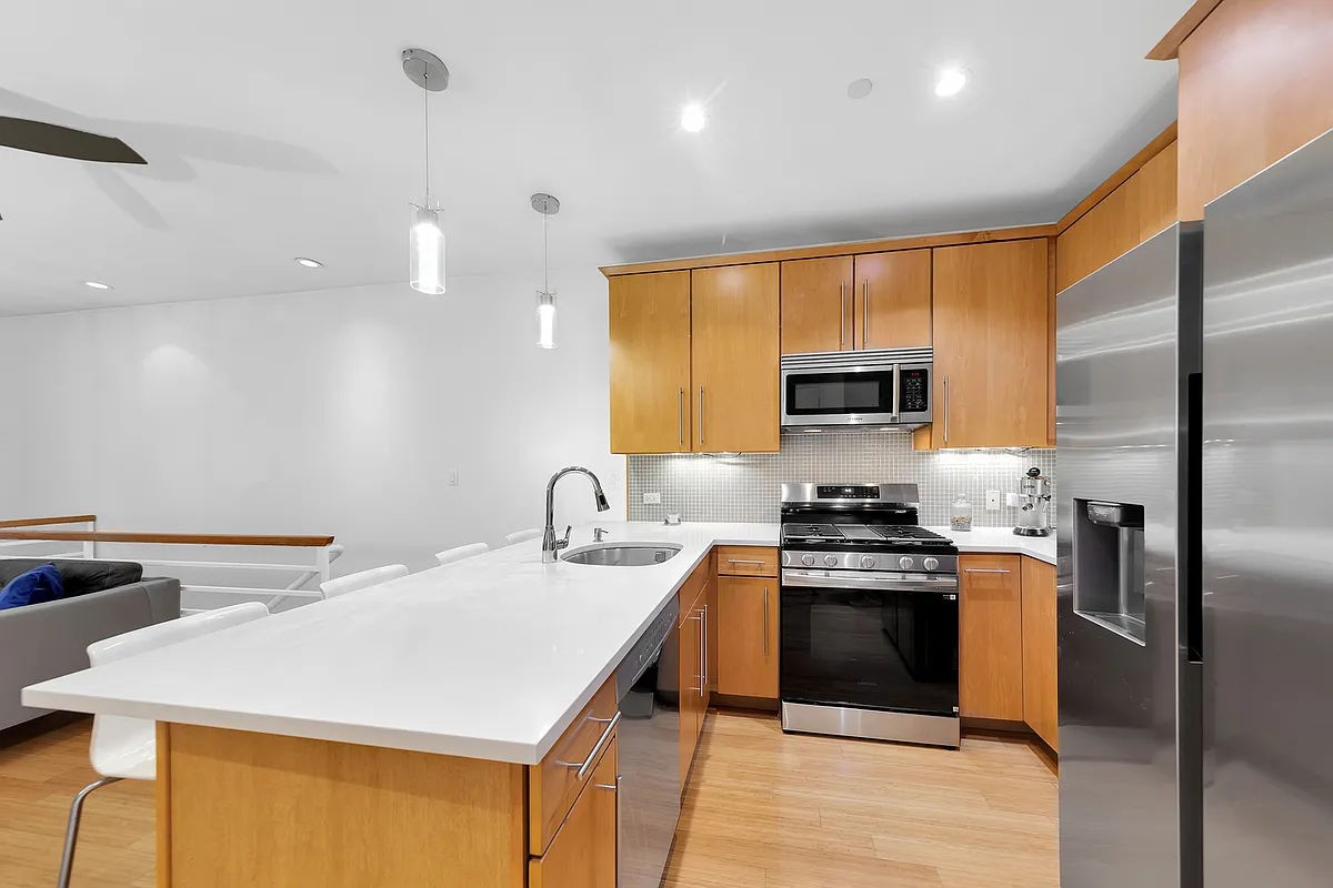 a kitchen with a stove a sink and a refrigerator