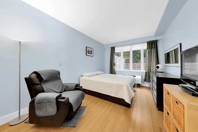 a bedroom with furniture and a window